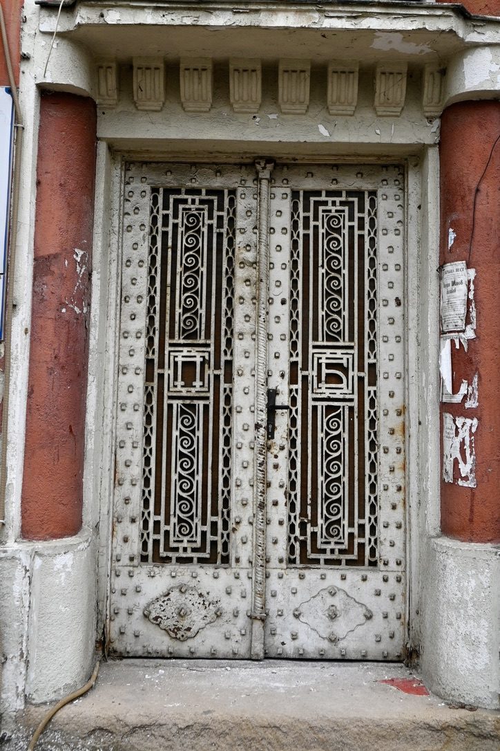 An ornate studded iron door with spiral ironwork