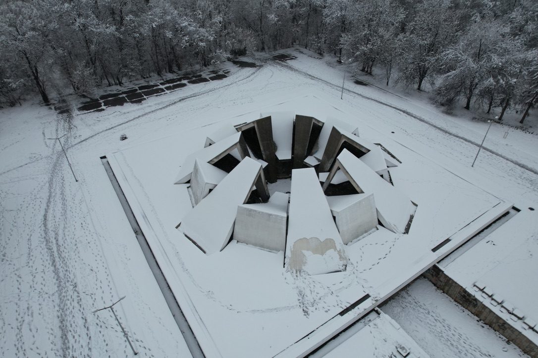 A snow-covered monument of angled concrete blocks, seen from above
